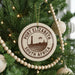 A Christmas tree decorated with ornaments, including a circular ornament with the text "PORT ELIZABETH SOUTH AFRICA" printed on it.