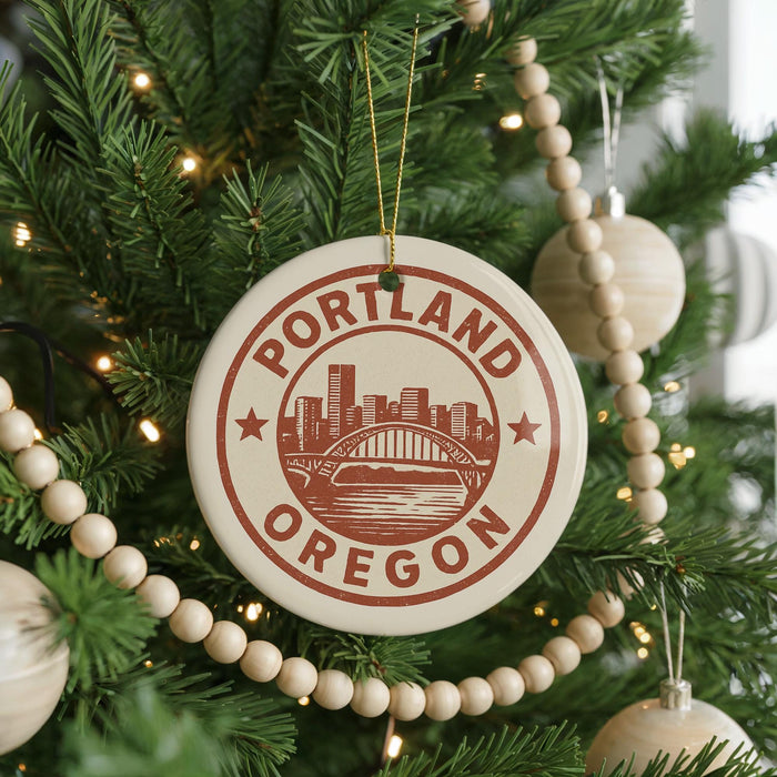 A Christmas tree decorated with ornaments, including a circular ornament with the text "PORTLAND OREGON" and a graphic of a city skyline.