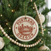 A Christmas tree decorated with ornaments, including a circular ornament with the text "PORTLAND OREGON" and a graphic of a city skyline.