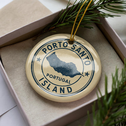 A circular ornament with the text "PORTO SANTO ISLAND" printed on it, surrounded by pine branches.