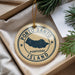 A circular ornament with the text "PORTO SANTO PORTUGAL ISLAND" printed on it, hanging from a string.