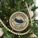 A Christmas tree decorated with ornaments, including a circular ornament with the text "PORTO SANTO PORTUGAL ISLAND" printed on it.