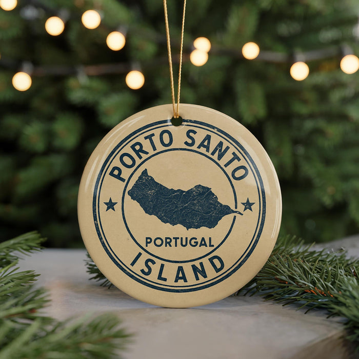 A circular ornament with the text "PORTO SANTO PORTUGAL ISLAND" printed on it, hanging from a string.