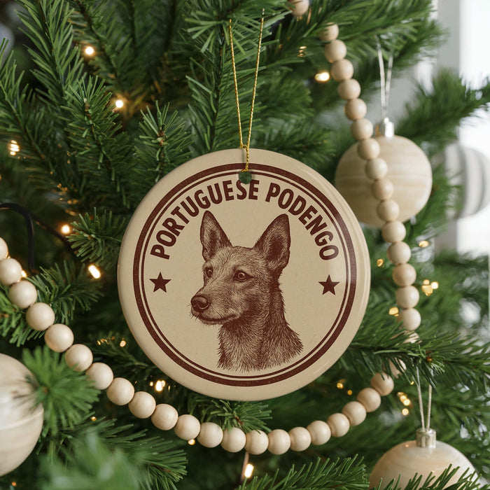 A round ornament on a Christmas tree featuring a dog's head and the text "PORTUGUESE PODENGO".