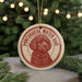 A round ornament featuring a red and white illustration of a Portuguese Water Dog, with the text "Portuguese Water Dog" around the edge.