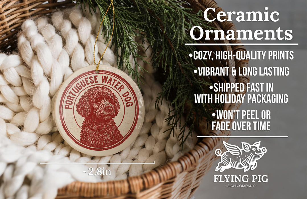 a ceramic ornament in a basket, with a red and white design depicting a Portuguese Water Dog. The ornament is described as cozy, high-quality prints, vibrant, and long lasting, and is shipped fast in holiday packaging. It is also noted that the ornament won't peel or fade over time.