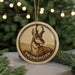 A round ornament featuring a deer with antlers, with the word "PRONGHORN" written around the deer's neck.