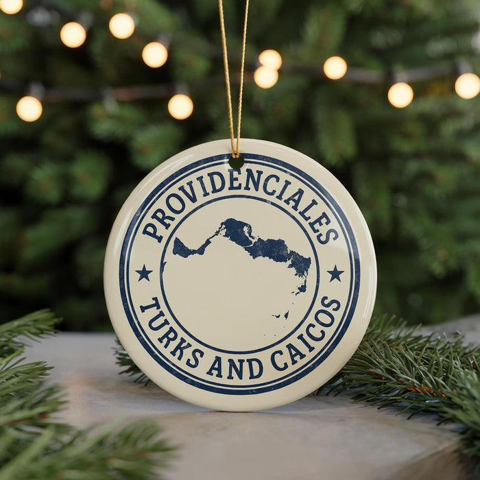 A round ornament with the text "PROVIDENCIALES TURKS AND CAICOS" printed on it, hanging from a string.