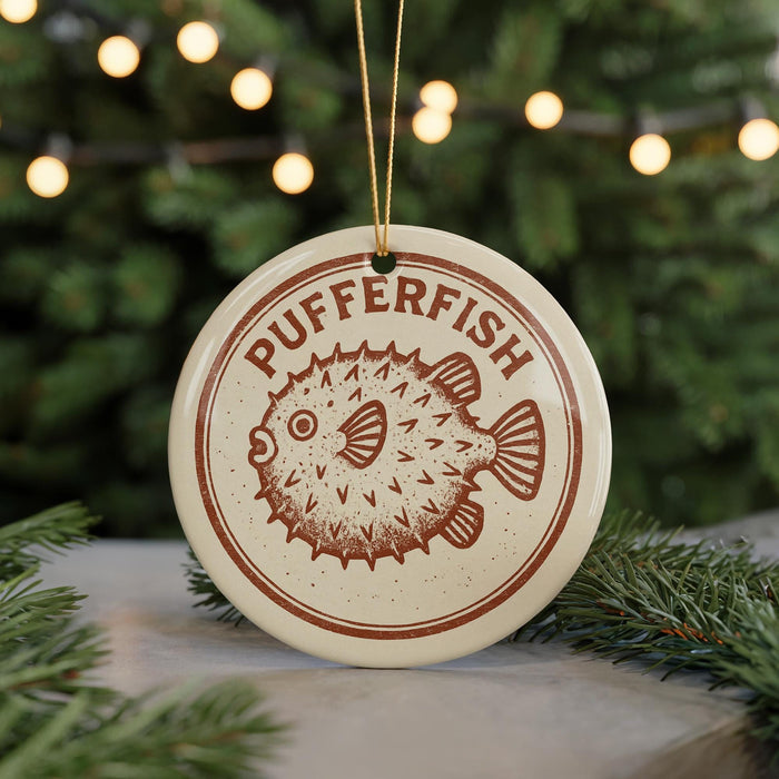 A round ornament with the word "PUFFERFISH" printed on it, featuring a pufferfish design.
