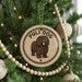 A Christmas tree decorated with ornaments, including a circular ornament with a picture of a poodle and the text "PULI DOG" on it.