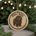 A round ornament with the text "PULI DOG" and an illustration of a shaggy dog is displayed in front of a Christmas tree with twinkling lights.
