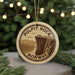 A circular ornament with the text "PULPIT ROCK NORWAY" printed on it, featuring an illustration of a cliff with people standing on the edge.