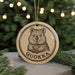 A round ornament featuring a cartoon image of a wombat, with the word "QUOKKA" written below it.