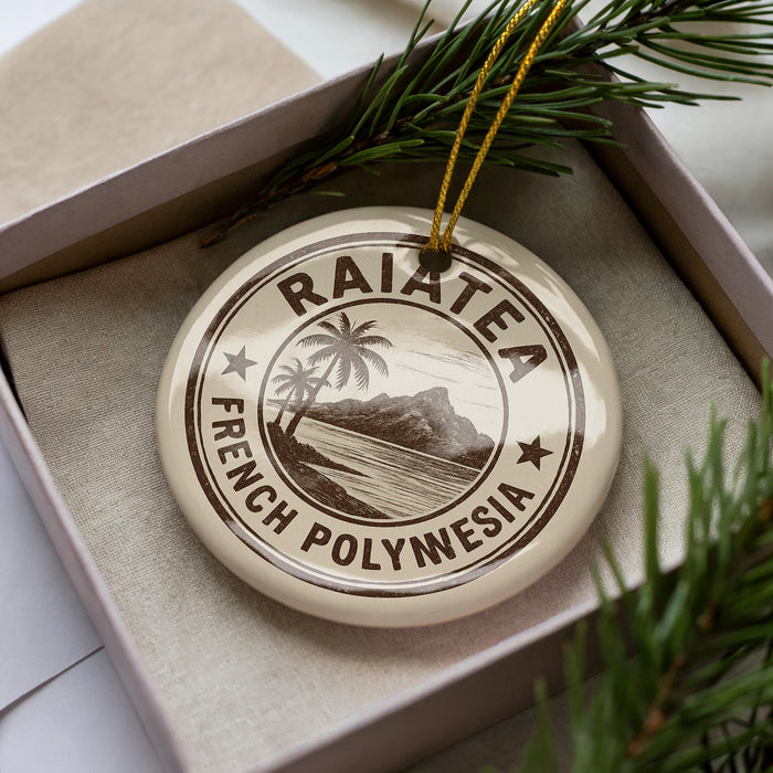 A circular ornament with the text "RAIATEA FRENCH POLYNESIA" printed on it, surrounded by pine branches.