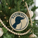 A Christmas tree decorated with ornaments, including a circular ornament with a graphic of a penguin and the text "RAZORBILL".