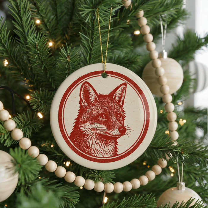 A Christmas tree decorated with ornaments, including a red and white fox ornament hanging from the tree.