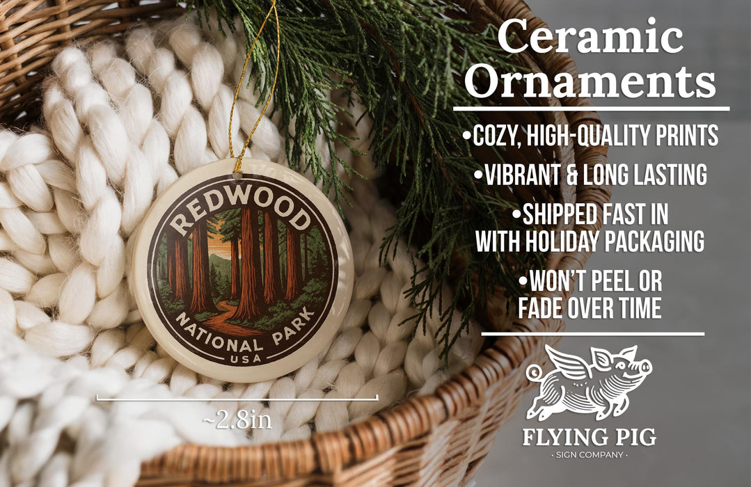 Ceramic ornaments, featuring a ceramic ornament with a forest scene and text, placed in a woven basket with pine branches.