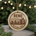 A circular ornament with the text " Reno Nevada USA" printed on it, featuring a cityscape illustration.