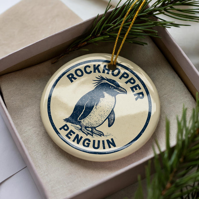A decorative ornament in a box, featuring a penguin image and the text "ROCKHOPPER PENGUIN".