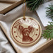 A round ornament with a dog image and the text "Russian Toy" is displayed in a box, surrounded by pine branches.