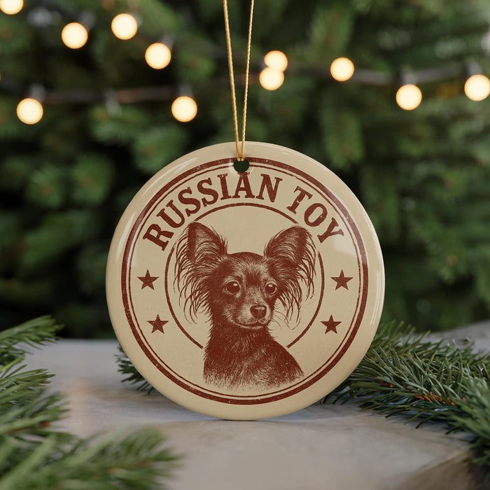 A round ornament with a dog image and the text "Russian Toy" on it, hanging from a string.