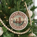 A round ornament on a Christmas tree, featuring a graphic of the Golden Gate Bridge in Sacramento, California.