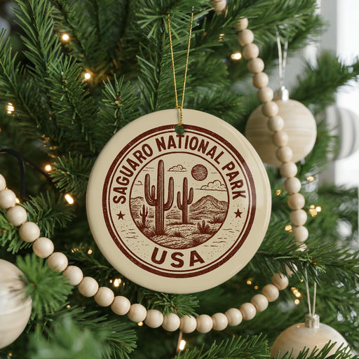 A Christmas tree decorated with ornaments, including a circular ornament with the text "SAGUARO NATIONAL PARK USA" and a cactus design.