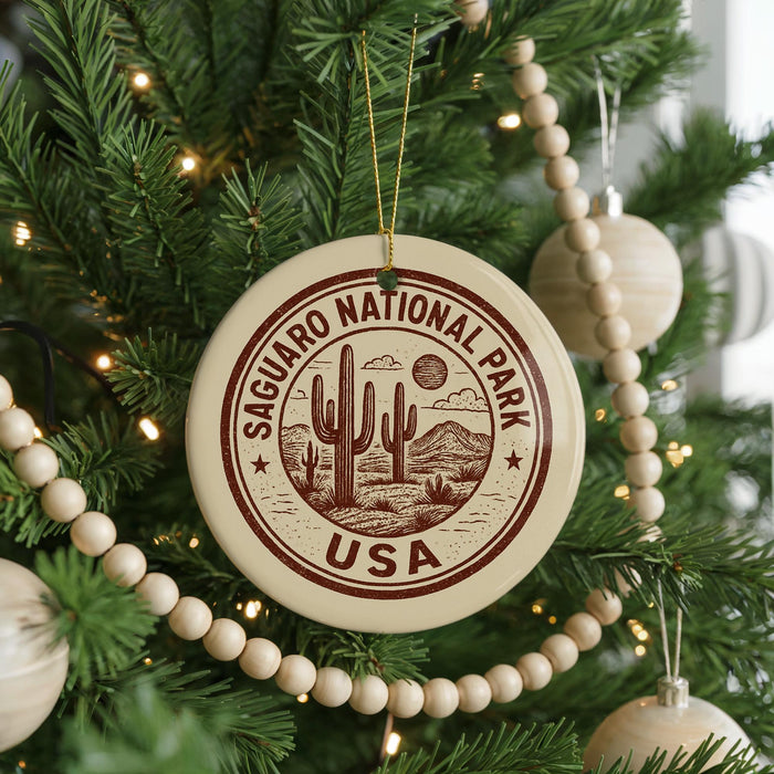 A Christmas tree decorated with ornaments, including a circular ornament with the text "SAGUARO NATIONAL PARK USA" and a cactus design.