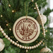 A Christmas tree decorated with ornaments, including a circular ornament with the text "SAGUARO NATIONAL PARK USA" and a cactus design.