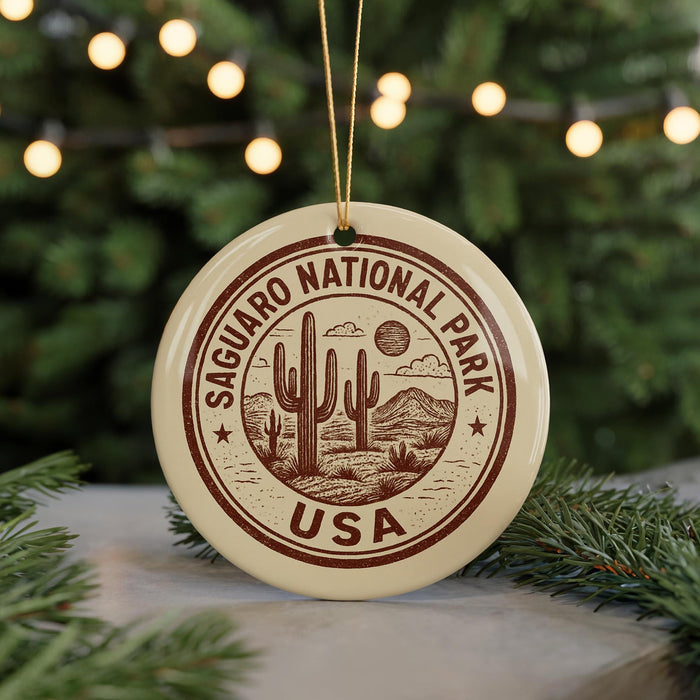 A circular ornament with the text "SAGUARO NATIONAL PARK USA" and a graphic of a cactus and mountains, hanging from a string.