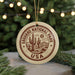 A circular ornament with the text "SAGUARO NATIONAL PARK USA" and a graphic of a cactus and mountains, hanging from a string.