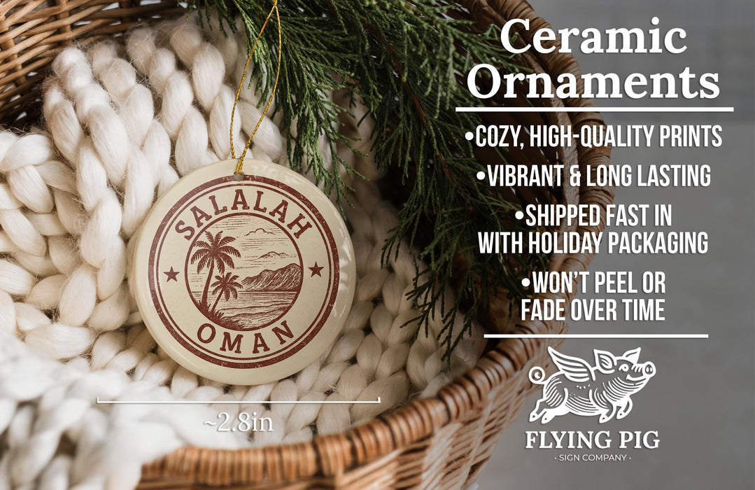 Ceramic ornaments, specifically a round ornament with a palm tree design, are displayed in a woven basket.