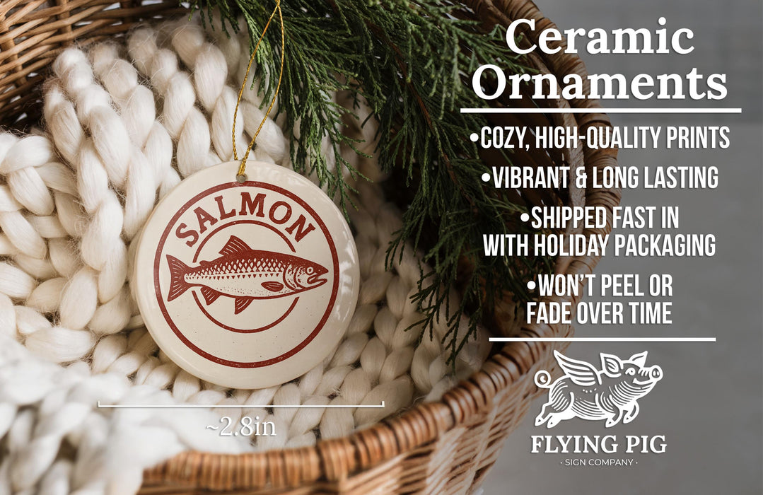 Ceramic ornaments, including a salmon ornament, are displayed in a woven basket.
