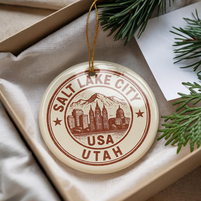 A circular ornament with the text "Salt Lake City USA" and an illustration of the Salt Lake City skyline, hanging from a string.