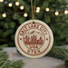A circular ornament with the text "Salt Lake City USA Utah" printed on it, featuring a graphic of a mountain and buildings.