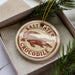 A circular ornament with the text "Saltwater Crocodile" printed on it, surrounded by a decorative border.