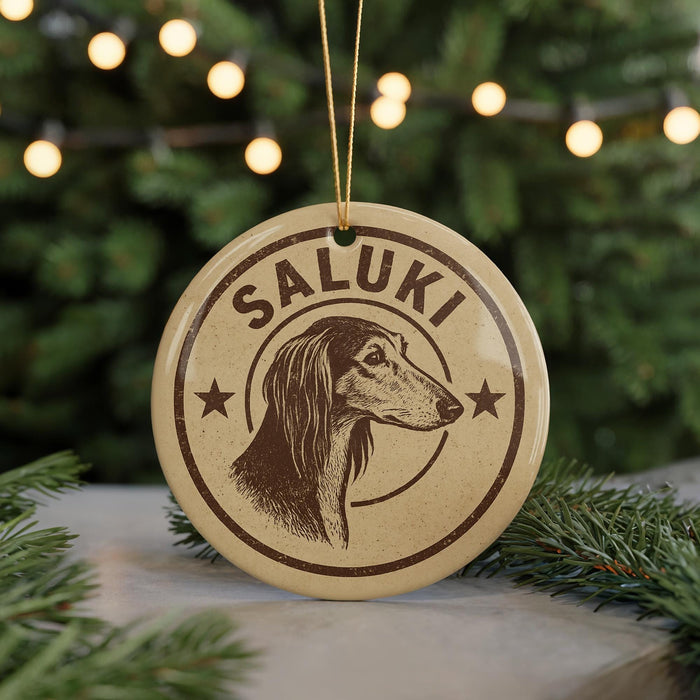 A circular ornament with the name "Saluki" and a dog's head illustration, hanging from a string.