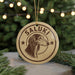 A circular ornament with the name "Saluki" and a dog's head illustration, hanging from a string.