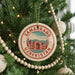A circular ornament on a Christmas tree, featuring the text "SAMARKAND UZBEKISTAN" and an illustration of a mosque.