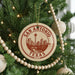 A circular ornament on a Christmas tree, featuring the text "SAN ANTONIO TEXAS U.S.A." and an illustration of the city skyline.