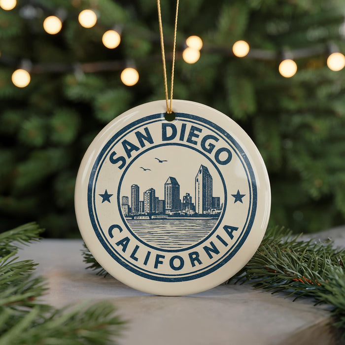 A circular ornament with the text "SAN DIEGO CALIFORNIA" and a graphic of a city skyline, hanging from a string.