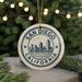 A circular ornament with the text "SAN DIEGO CALIFORNIA" and a graphic of a city skyline, hanging from a string.