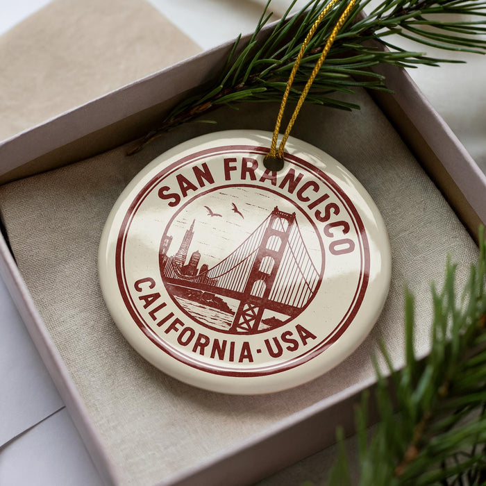 A circular ornament with the text "SAN FRANCISCO CALIFORNIA-USA" printed on it, surrounded by pine branches.