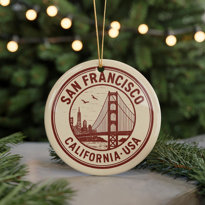 A circular ornament with the text "SAN FRANCISCO CALIFORNIA USA" and a graphic of the Golden Gate Bridge, hanging from a string.