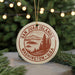 A circular ornament with the text "SAN JUAN ISLANDS WASHINGTON, U.S.A." printed on it, surrounded by pine branches and twinkling lights.