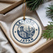 A decorative ornament with the text "SAPPORO JAPAN" printed on it, hanging from a string.