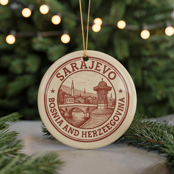 A circular ornament with the text "SARajevo, Bosnia and Herzegovina" and an illustration of a cityscape is hanging from a string.