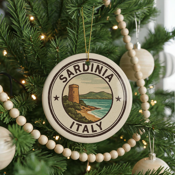 A Christmas tree decorated with ornaments, including a circular ornament with the text "SARDINIA ITALY" and a lighthouse image.