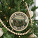 A round ornament on a Christmas tree, featuring a scenic image of Saxon Switzerland and Germany.