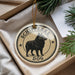 A round ornament with a black dog image and the text "Schipperke Dog" is displayed in a box with pine branches.
